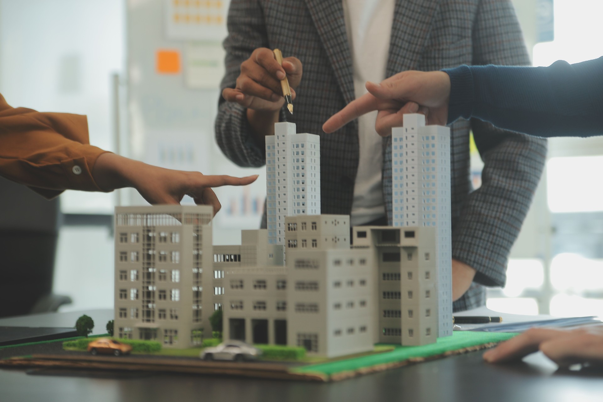 Team of architectures and businessmen discussing and brainstorming on floor plan modification for real estate investment and housing development project